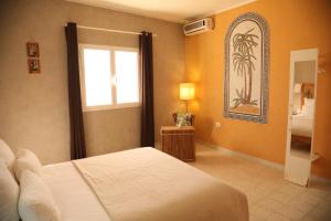 a bedroom with a white bed and a window at Dar Elferdaous in Al Medou +53 photos