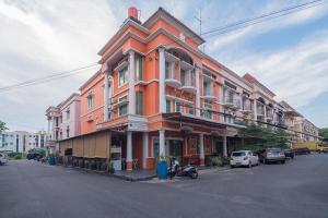 a large orange building on the side of a street at RedDoorz @ Batam Center 2 in Batam Center