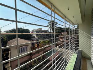 a balcony with a view of a train at Zen Luxe Abode in Siliguri