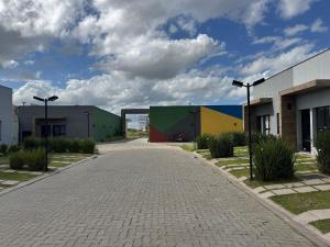 a cobblestone street in front of some buildings at Condomínio Noruega - casas 2 dormitórios in Jaguarão