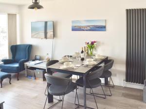 a dining room with a table and chairs at Seagulls View in Brixham