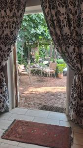 an open door to a patio with a table and chairs at Michael-Angelo guest house in Potchefstroom