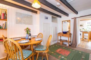 a dining room with a wooden table and chairs at 1 Caerau Isaf in Haverfordwest