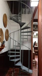 a metal spiral staircase in a living room with at APARTAMENTO La CAVA in Guadalcanal