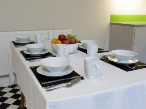 a table with plates and bowls of fruit on it at Blue Star House in Portsmouth