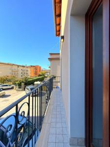 a balcony of a building with a view of a street at MECE Rooms in LʼAquila +18 photos