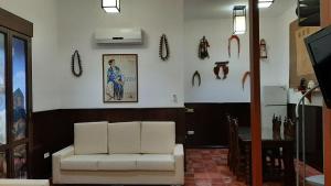 a living room with a white couch and some decorations on the wall at APARTAMENTO La CAVA in Guadalcanal