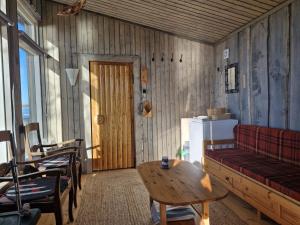 a living room with a red couch and a table at Villa Vonkale in Äänekoski