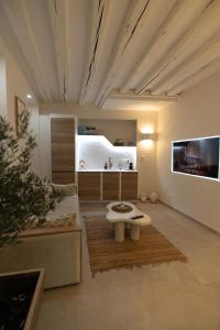 a living room with a couch and a table at La Suite Grecque in Mitry-Mory