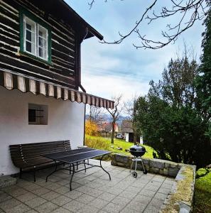 a picnic table and a grill next to a house at Roubenka Vendryně in Vendryně