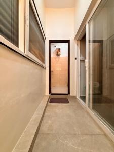 a hallway with a door leading into a room at Rajkamal Hampi in Hampi
