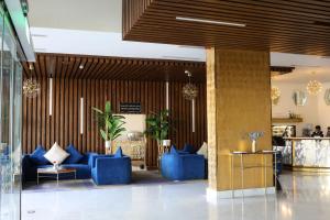 a lobby with blue couches in a building at Gorash Hotel in Khamis Mushayt +75 photos