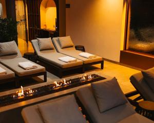 a living room with couches and candles in it at Planet Residence Royal Studio & SPA in Niš