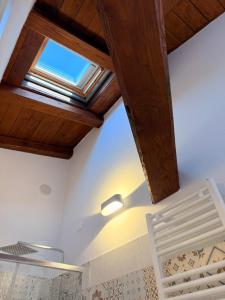 a bedroom with a skylight on the ceiling at MECE Rooms in LʼAquila