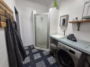 a bathroom with a shower and a washing machine at 12 On Milner in Kimberley +79 photos