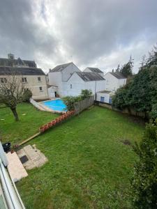 a backyard with a yard with a pool and houses at Gîte 4 Le Cerizay - proche du PuyduFou in Cerizay