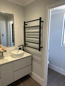 a bathroom with a sink and a mirror at Slate House Caversham in Caversham