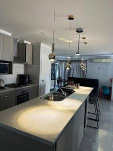 a kitchen with a sink and a counter top at Slate House Caversham in Caversham +31 photos
