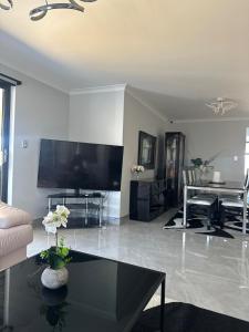 a living room with a large flat screen tv at Slate House Caversham in Caversham
