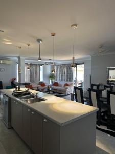 a kitchen and living room with a kitchen island and a living room at Slate House Caversham in Caversham
