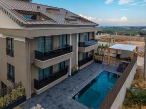 an aerial view of a house with a swimming pool at Moon Shine Apart in Altınkum