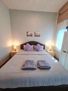a bedroom with a bed with two towels on it at Samati Hill - Pool Villa H2- Klong Ning Beach in Ko Lanta Yai +61 photos
