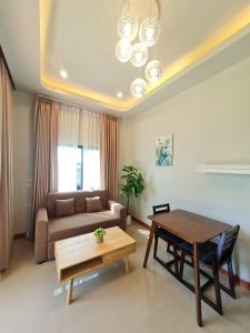 a living room with a table and a couch at Samati Hill - Pool Villa H2- Klong Ning Beach in Ko Lanta Yai