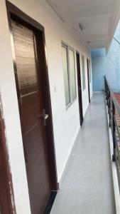 an empty corridor with a door in a building at Valiyaveettile in Alwaye
