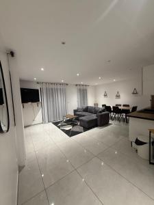 a living room with a couch and a table at Maison centre-ville in Dijon