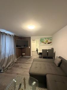 a living room with a couch and a table at Ferienwohnung Nabo in Wadgassen