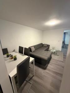a living room with a couch and a table at Ferienwohnung Nabo in Wadgassen