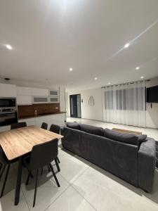 a living room with a long couch and a table at Maison centre-ville in Dijon