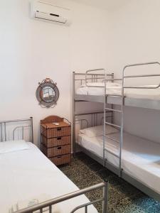 a room with two bunk beds and a mirror at Dimitreli Beach House in Telendos