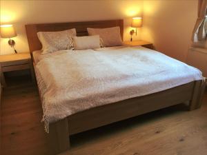 a bedroom with a large bed with two night stands at Ferienwohnung Kogelblick Gosau in Gosau