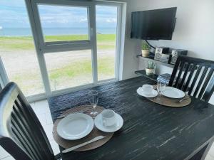 a dining room table with a view of the ocean at Apartment Potosi Teichhof Fehmarn in Wenkendorf +31 photos