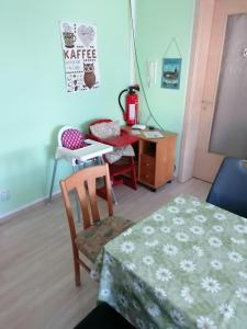 a room with a table and a chair and a desk at Gaestehaus Remde in Erfurt