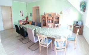 a kitchen and dining room with a table and chairs at Gaestehaus Remde in Erfurt