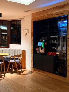 a restaurant with a bar with a table and chairs at Tieflehner Hof Pitztalhaus Hotel in Sankt Leonhard im Pitztal