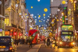 a busy city street with double decker buses and people at Moxy London Piccadilly Circus in London