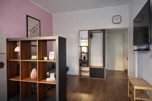 a living room with a room with a clock on the wall at NEST by Tendo Stay - Comfort Housing in Falkensee