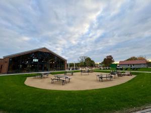 a group of tables and benches in front of a building at Caravanserei Resort Oberhavel in Oranienburg