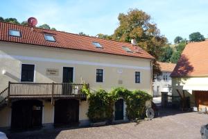 a large white building with a balcony on it at Barthmühle in Klipphausen
