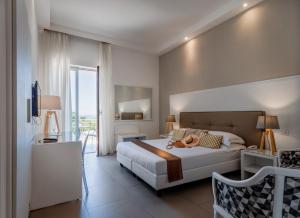 a bedroom with a large white bed and a balcony at Hotel Rivage in Sorrento +100 photos