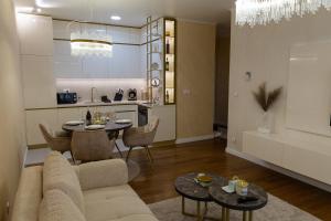 a living room with a couch and a table at Premium Planet Deluxe & SPA in Niš