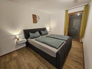 a bedroom with a bed and a window at RoSa Haus in Steingaden