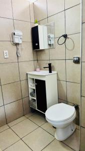 a bathroom with a toilet and a phone on the wall at Monoambiente Eldorado 1 in Eldorado