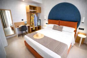 a bedroom with a large bed with a blue headboard at Essenza Mediterranea Tropea in Tropea +58 photos