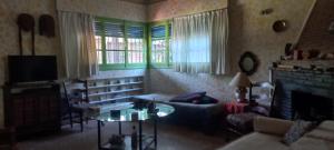 a living room with a couch and a table at La casa de los titiriteros in Mina Clavero