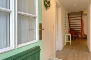 a hallway of a house with a window and a staircase at Haus Arfsten "Elena", Nieblum in Nieblum