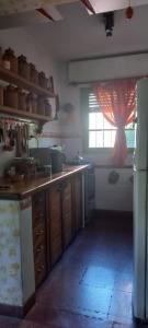a kitchen with a counter and a window in it at La casa de los titiriteros in Mina Clavero